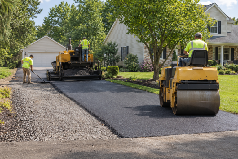 Professional crew installing and compacting an asphalt driveway in Eagleville PA